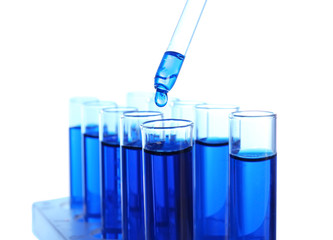 Dripping blue liquid into test tubes on white background
