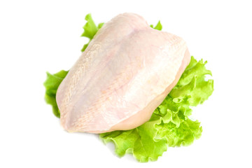 Raw chicken breast and green salad isolated on white background.