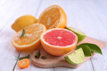 Naklejka na ściany i meble Fresh ripe citrus fruits on white wooden table