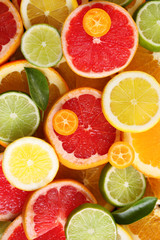 Fototapeta na wymiar Slices of fresh citrus fruits as background