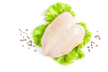 Raw chicken breast and green salad isolated on white background.