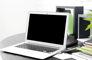 Fototapeta na wymiar Stylish modern workplace with laptop at home
