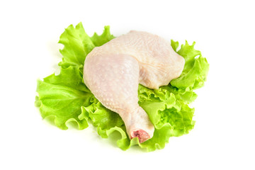 Raw chicken legs and green salad isolated on white background.