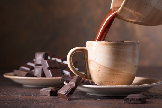 Cup of hot chocolate and bitter chocolate pieces.
