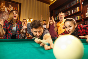 Close-up shot of a man playing billiard