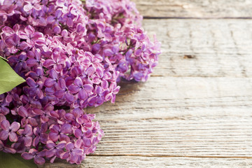 Beautiful lilac flowers on a wooden background copy space.