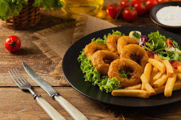 Roasted squid rings with fries.