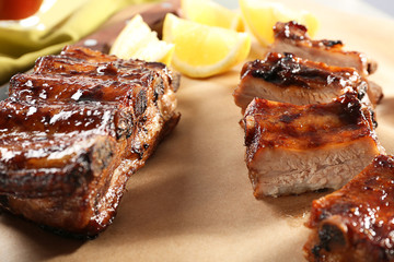 Delicious grilled ribs on table, closeup