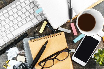 Workplace composition with smartphone, notebook and computer keyboard on table, flat lay