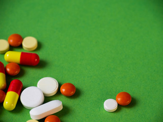 Tablets on a green background.Pills and tablets. Green background. Medical background.