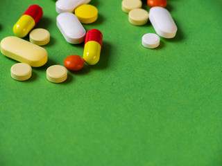 Tablets on a green background.Pills and tablets. Green background. Medical background.