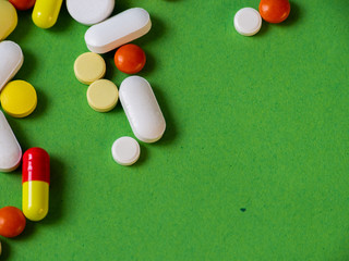 Tablets on a green background.Pills and tablets. Green background. Medical background.
