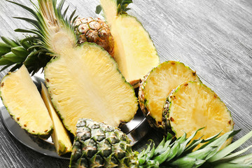 Cut ripe pineapples on wooden background