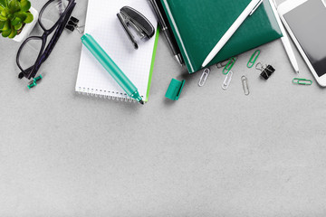 Workplace with stationery and phone on table. Top view