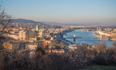 Fototapeta na wymiar Panoramic View of Budapest and the Danube River as Seen from Gellert Hill Lookout Point with Bare Trees and Bushes