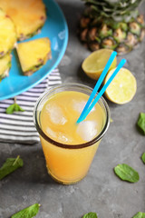 Glass of tasty fresh pineapple juice on table