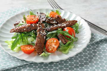 Tasty salad with meat and cherry tomatoes on plate