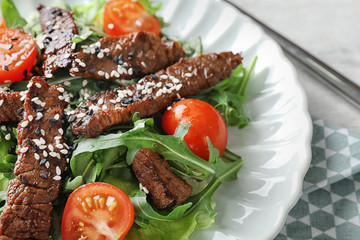 Tasty salad with meat and cherry tomatoes on plate