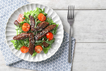 Tasty salad with meat and cherry tomatoes on plate