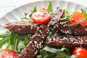 Tasty salad with meat and cherry tomatoes on plate