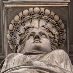 Caryatid stained sculpture adorns the old house facade on the street of Budapest