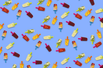 Pattern of fruit popsicle on a blue background. Strawberry, Lemon, Lemon with mint, Orange, Cherry, Multifruit. Flat lay, top view