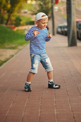 Fototapeta premium little boy dancing on the street