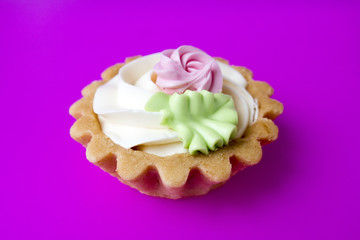 Cake basket of short pastry cream closeup on a purple background