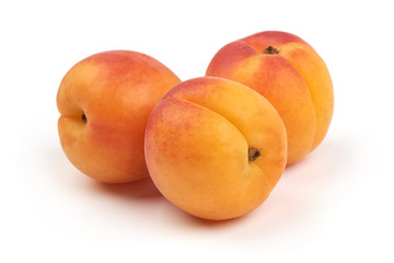Fresh whole apricots, isolated on white background.