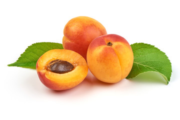 Fresh whole apricots with leaf and half with core, isolated on white background.