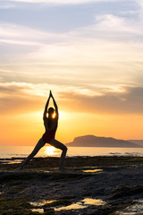 Fototapeta na wymiar Meditation girl on the sea during sunset. Yoga silhouette. Fitness and healthy lifestyle