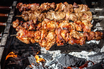 Shish kebabs with grilled meat for barbecue. Close-up pieces of juicy meat on skewers. Preparation...