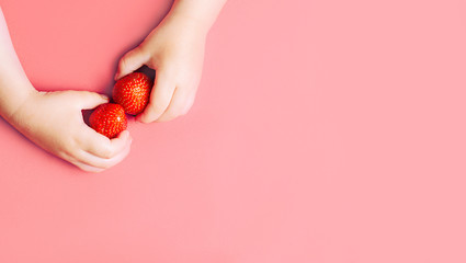 Child's hands holding strawberries