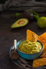 Plate of homemade guacamole with nachos.