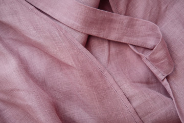Fototapeta premium Blush pink soft linen fabric texture. Delicate sensual folds. Fashion designer textile concept