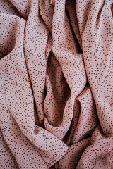 Creative art photography made of fabric in nude pink color. Vagina concept, female energy