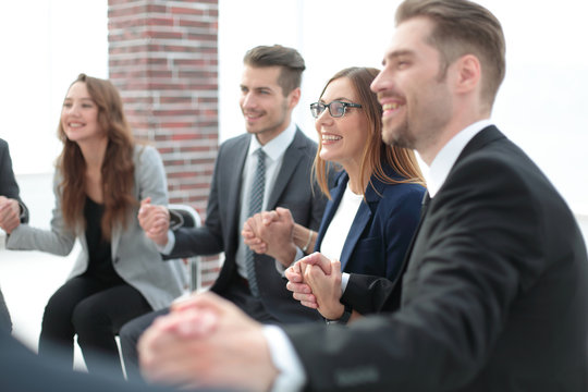 A group of businessmen holding hands in a circle