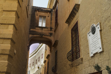 Rabat, Malta architecture detail. Arched balcony in fortified Old Town with limestone buildings.