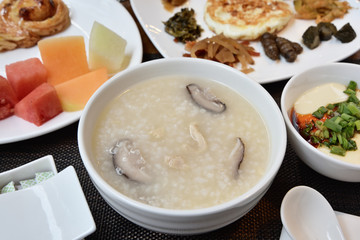 Mushroom meat porridge served with side dish.