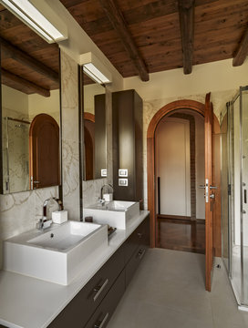 modern bathroom interior in the foreground the countertop washbasin on the background the wooden door