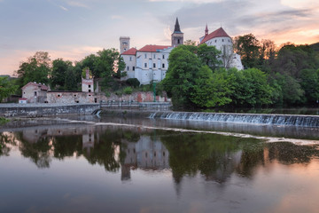 Sunset over Sazava monastery with reflection river foreground, Czech Republic