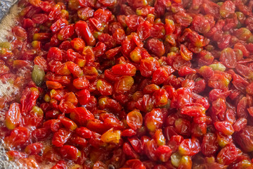 Sweet tomatoes. Food preservation.Jam of small red tomatoes.