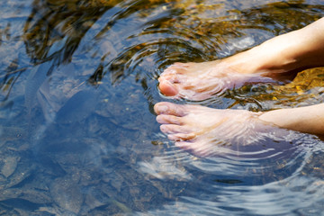 Woman Relax Her Foot in The River Stream and Waterfall.