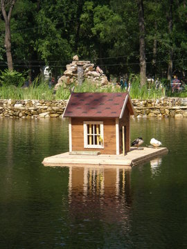 Pond  with bird house on the backdrop of an alphine  slide (Gorky park,Melitopol)