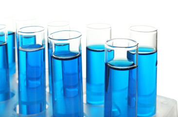 Test tubes with blue liquid on white background