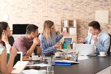 Young people having business meeting in office