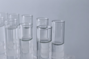 Test tubes with water on light background