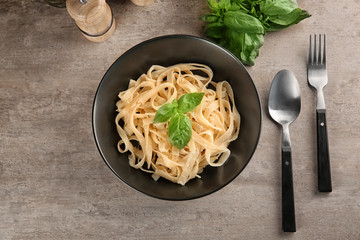 Plate of delicious pasta with cheese on table, top view