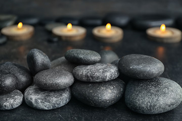 Obraz na płótnie Canvas Pile of spa stones on dark table