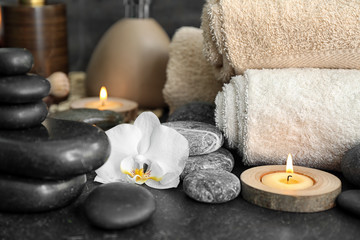 Fototapeta na wymiar Beautiful spa composition with stones and orchid flower on table